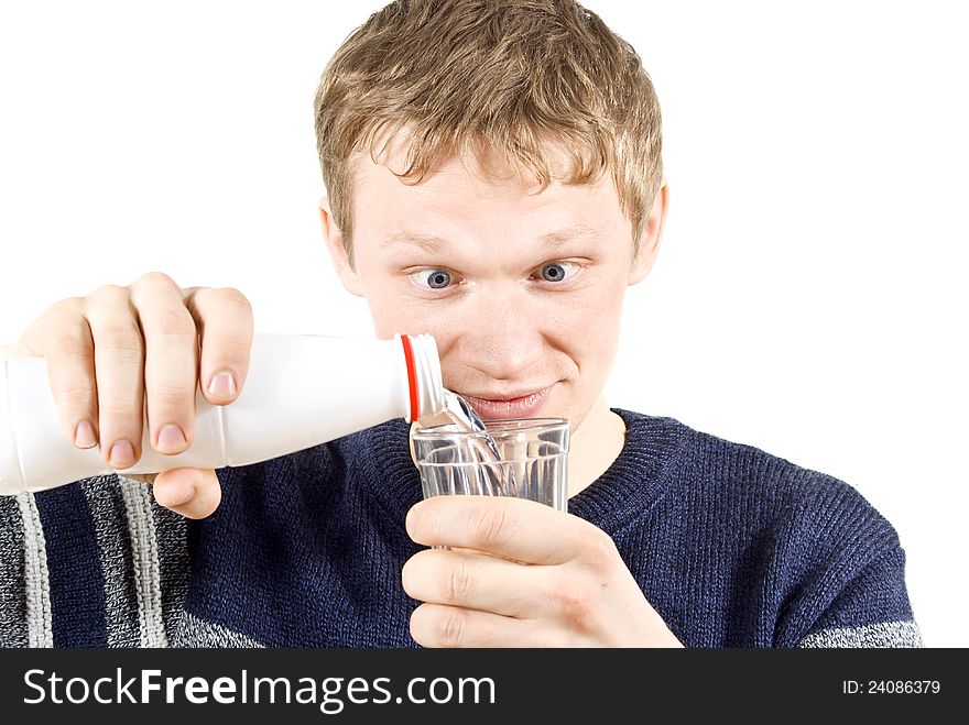 The guy pours water into a glass of isolated on white background