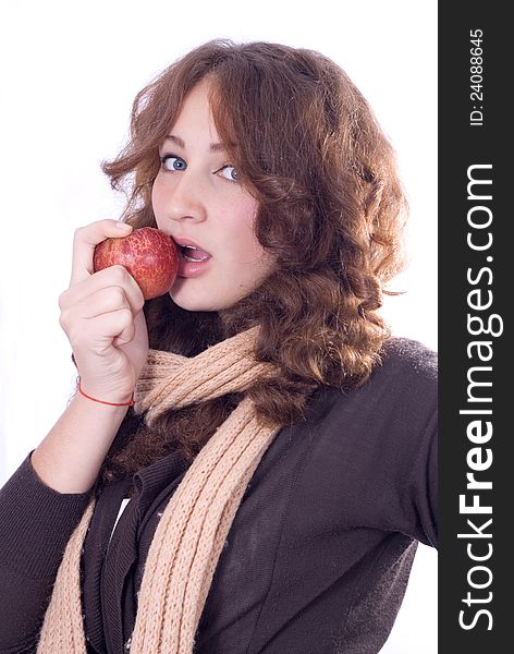 Young beautiful girl bites an apple isolated. Young beautiful girl bites an apple isolated