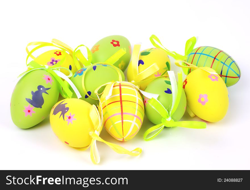 Yellow and green colored easter eggs on white