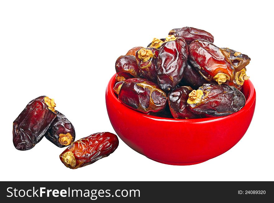 Dates in red ceramic bowl, isolated on a white background. Dates in red ceramic bowl, isolated on a white background