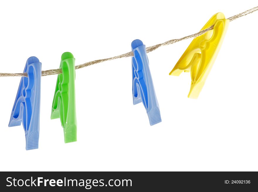 Four colour Clothespins on linen store isolated