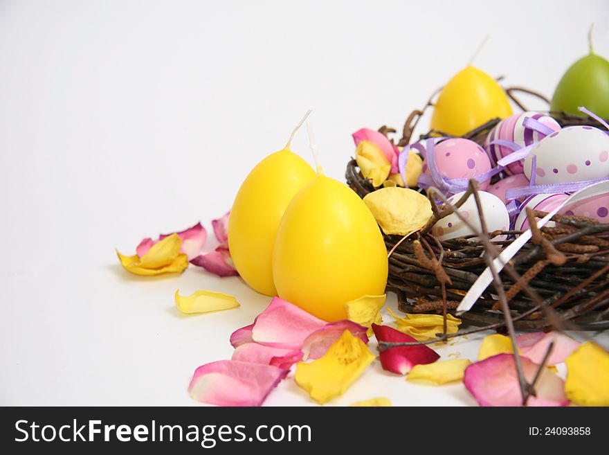 Multicolored Easter eggs in a nest and wicker basket. Multicolored Easter eggs in a nest and wicker basket