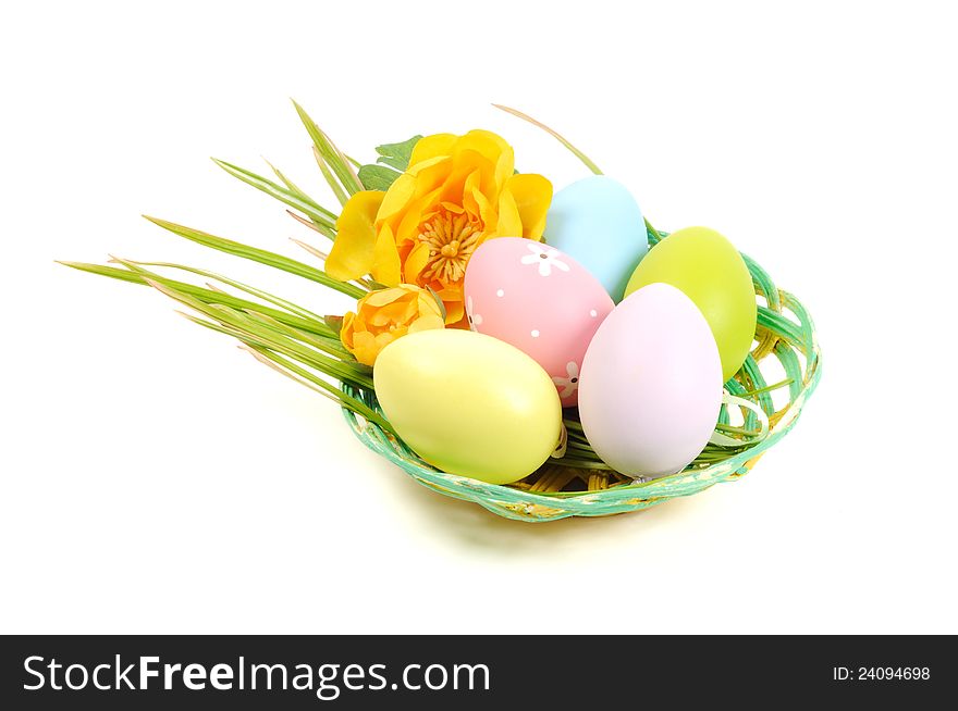 Colorful painted Easter eggs in a wooden plate, white background