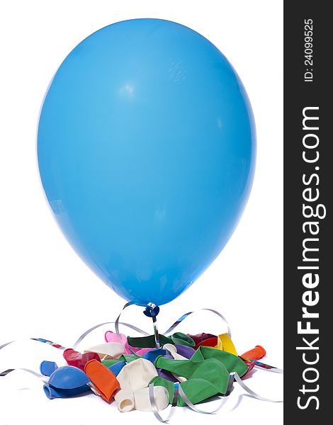 Inflated blue balloon and a bunch deflated colorful balloons isolated on a white background.