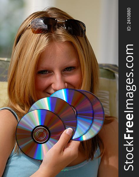Young girl with the fan from CD-disks. Young girl with the fan from CD-disks