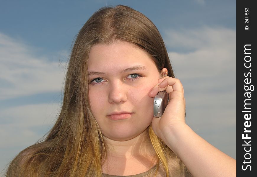 Young girl talks by the cell phone. Young girl talks by the cell phone