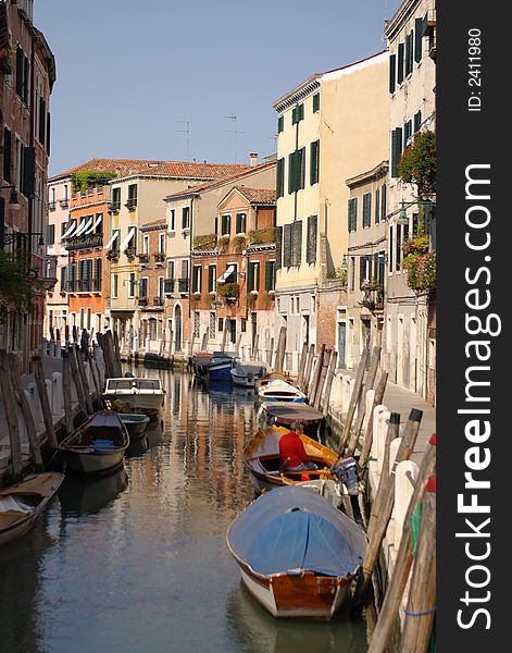 Channel in venice with quay, parked boats, houses. Venice. Italy, EU. Channel in venice with quay, parked boats, houses. Venice. Italy, EU