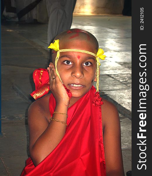 A boy chanting mantra in a Hindu religious ritual of thread ceremony.