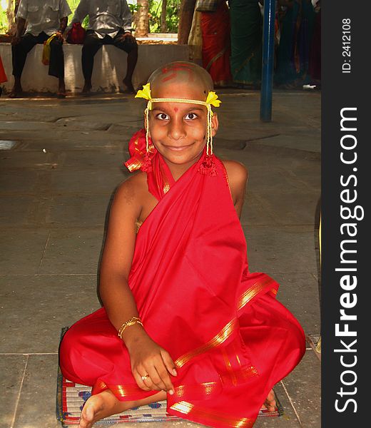 A boy in the dress of an Indian Monk sitting for a thread ceremony. A boy in the dress of an Indian Monk sitting for a thread ceremony.