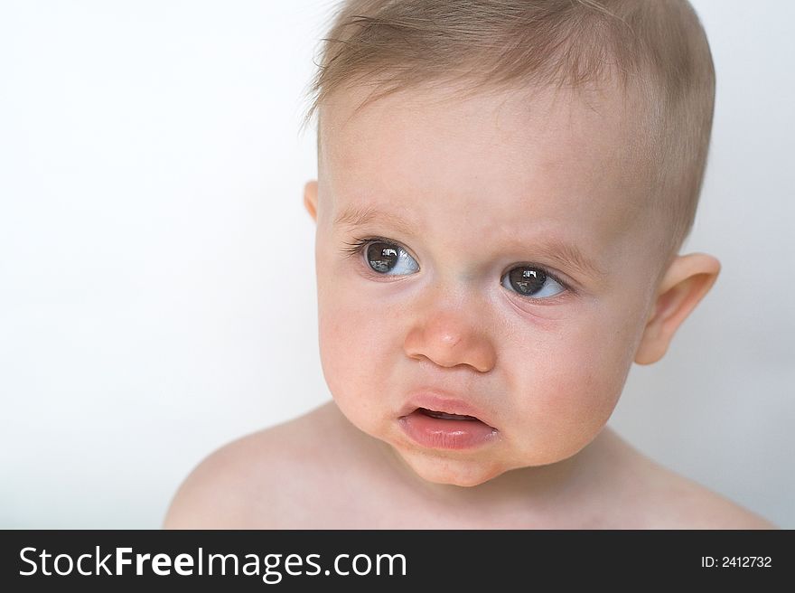 Image of beautiful 11 month old baby boy  sitting in front of a white background. Image of beautiful 11 month old baby boy  sitting in front of a white background