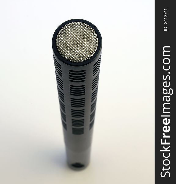 Close up of an upright Shotgun microphone against white background. Close up of an upright Shotgun microphone against white background