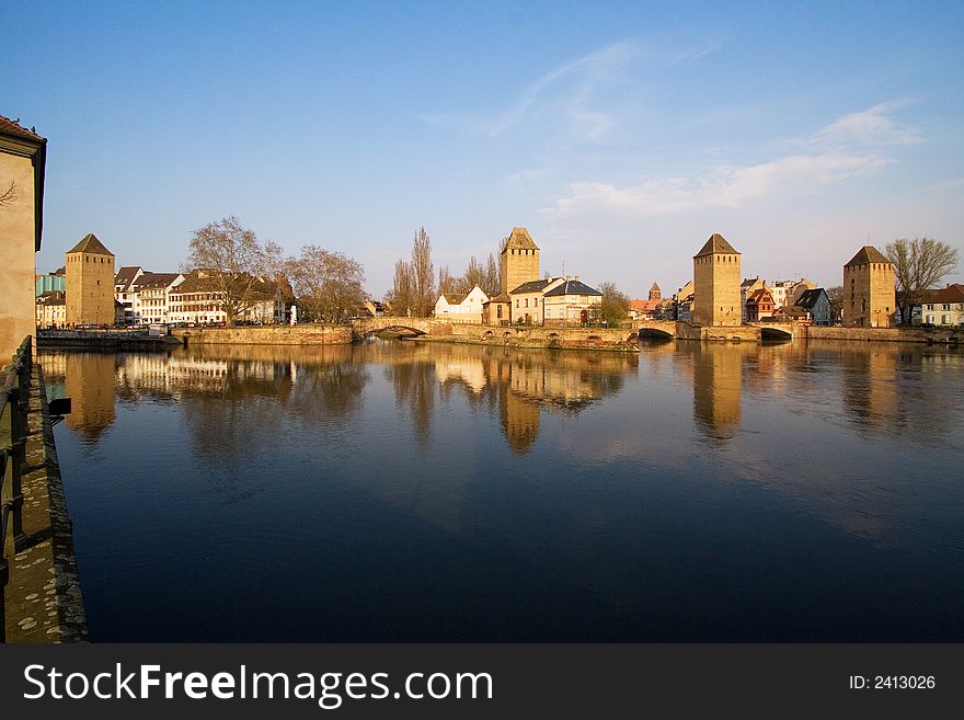 Four towers between covered bridges over the Ill river in Strasbourg. Four towers between covered bridges over the Ill river in Strasbourg