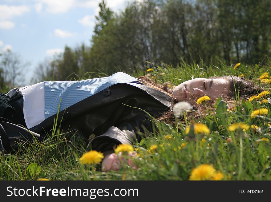 Sleeping young girl among grass and flowers. Sleeping young girl among grass and flowers