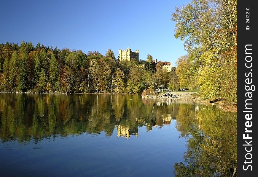 Royal castle Hohenschwangau, Bavaria, Germany. Alpensee in a foreground, blue sky in background.