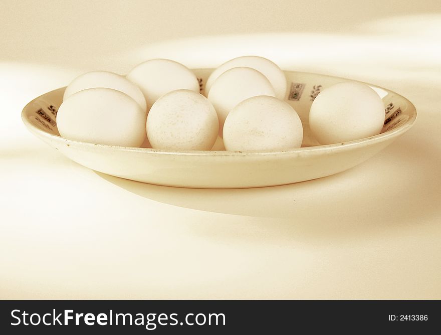Eight eggs on a platter, with soft sepia tone. Eight eggs on a platter, with soft sepia tone.