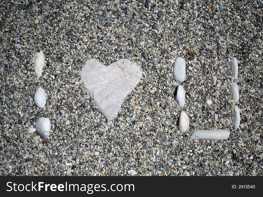 I Love U, written in the sand with pebbles. Fun and simple motif for love and affection. I Love U, written in the sand with pebbles. Fun and simple motif for love and affection.
