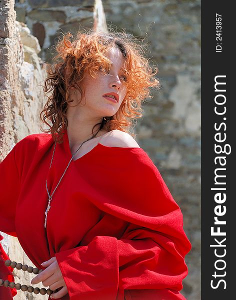 Girl in red cassock with beads