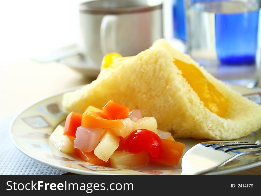 Mango cream cake with fruit cocktails nd coffee for breakfast. Mango cream cake with fruit cocktails nd coffee for breakfast