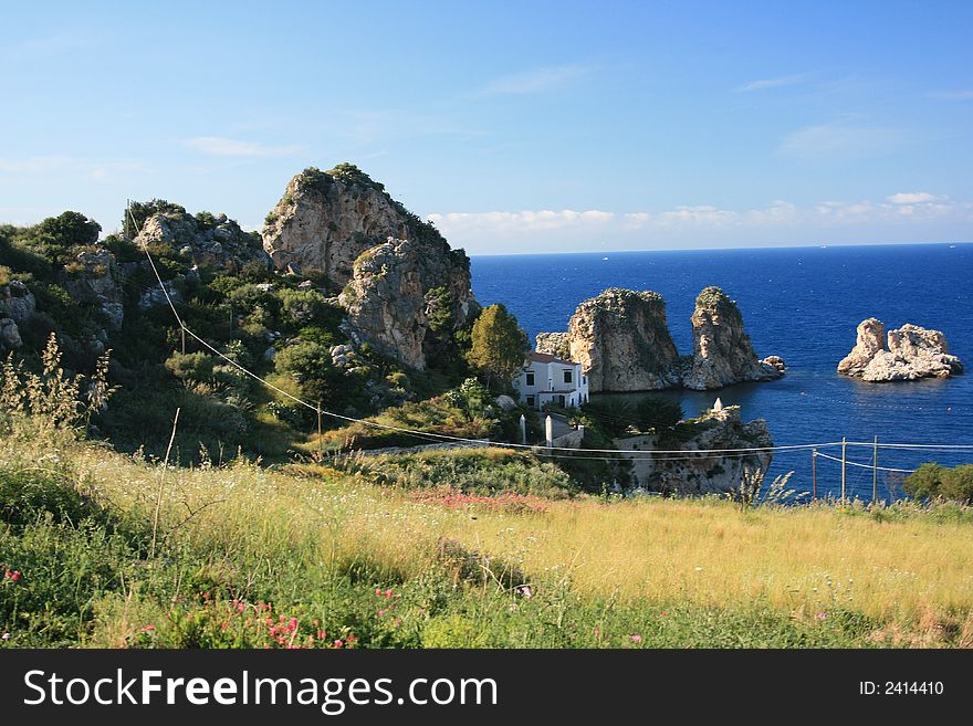 Blue Mediterranean Landscape. Coast, Rocks and sea. Season: spring /summer Sicily. Italy. Blue Mediterranean Landscape. Coast, Rocks and sea. Season: spring /summer Sicily. Italy