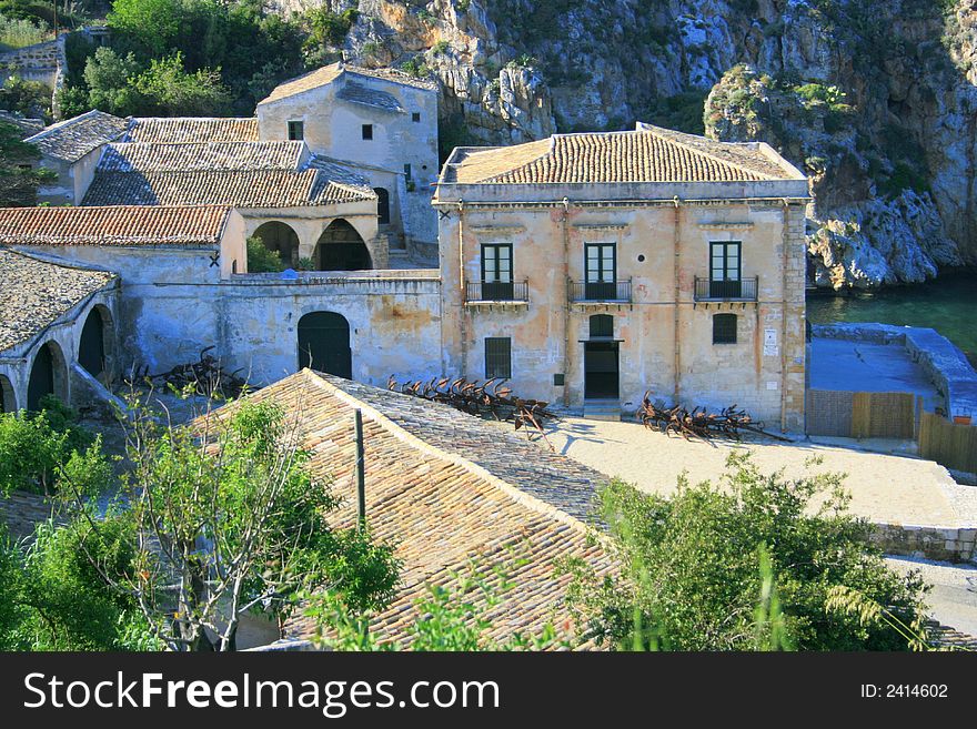 Blue Mediterranean Landscape. Coast, Rocks and sea.Wien on the ancient tuna fishing construction and bay. Sicily Summer Italy