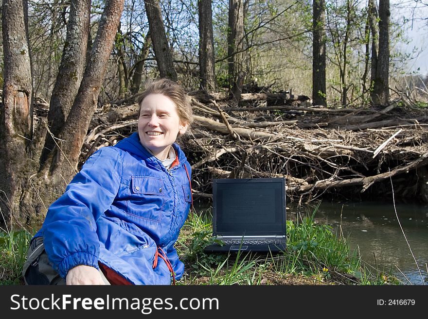 Woman with notebook at nature near small river