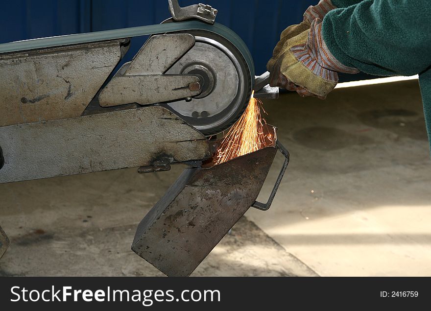 Steel being grinded in a mechanical workshop. Steel being grinded in a mechanical workshop