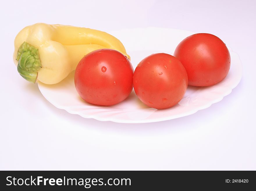 The fresh isolated vegetable on a white plate. The fresh isolated vegetable on a white plate