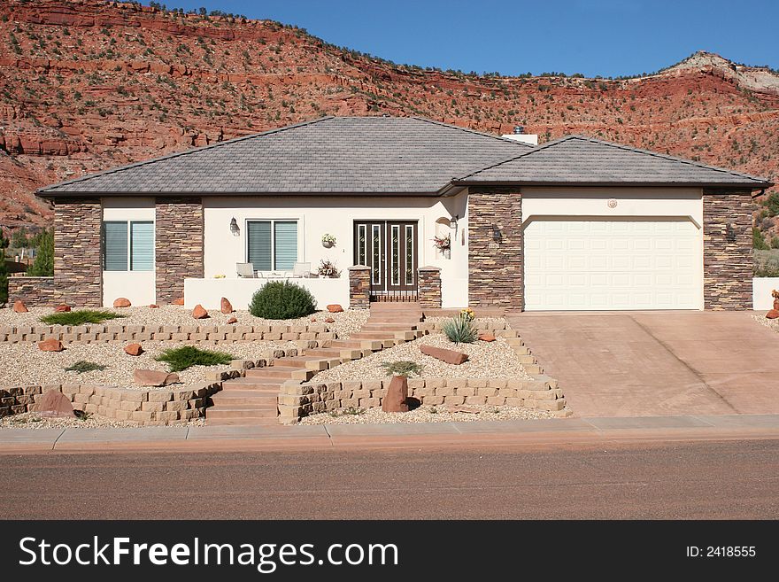 Lovely home with rock details, brick landscaping and a beautiful mountain backdrop. Lovely home with rock details, brick landscaping and a beautiful mountain backdrop.