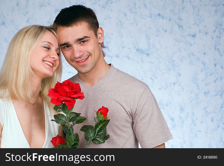 The guy, girl and a rose on blue background. The guy, girl and a rose on blue background