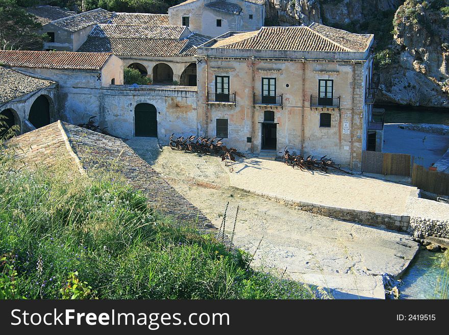 Blue Mediterranean Landscape. Coast, Rocks and sea.Wien on the ancient tuna fishing construction and bay. Sicily Summer Italy