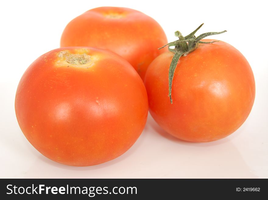 Some healthy red tomatoes on a white back drop setting. Some healthy red tomatoes on a white back drop setting.