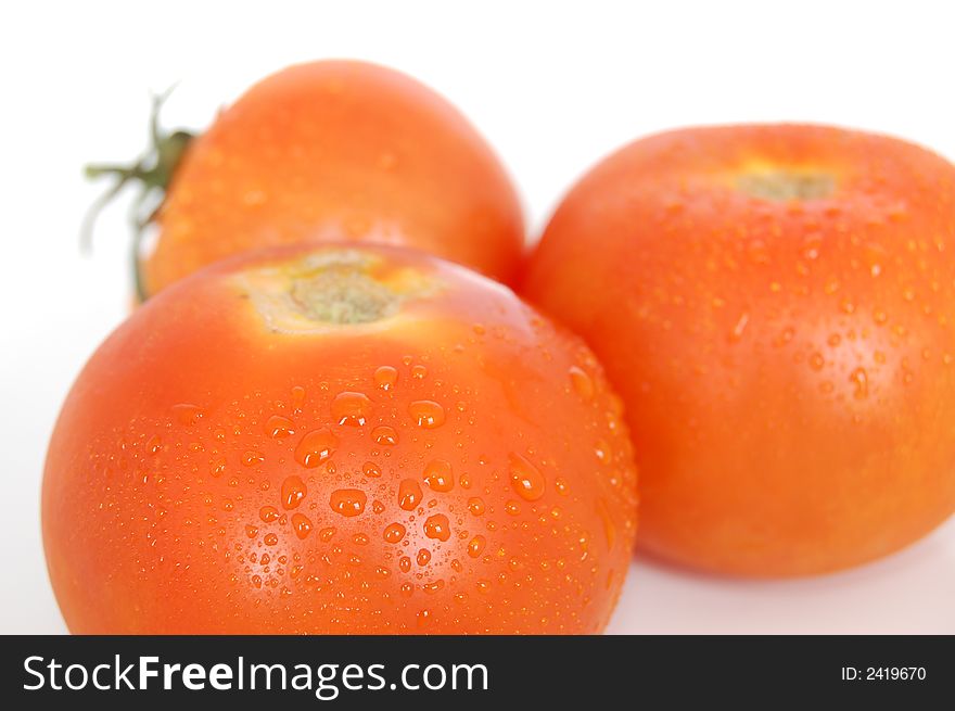 Some healthy red tomatoes on a white back drop setting. Some healthy red tomatoes on a white back drop setting.