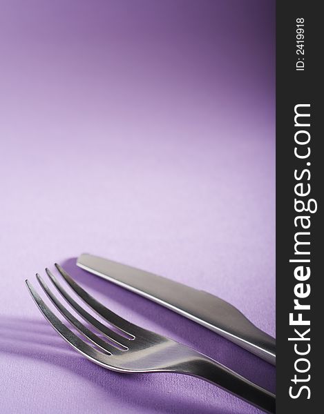 Fork and spoon on the purple table