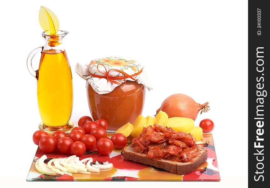 Still life with home canning jar of vegetable caviar and bottle of vegetable oil, cherry 
tomatoes, onion and potato. Still life with home canning jar of vegetable caviar and bottle of vegetable oil, cherry 
tomatoes, onion and potato.