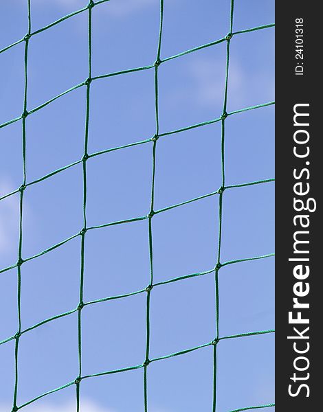 Partial view of a beach ball net field over a blue sky.