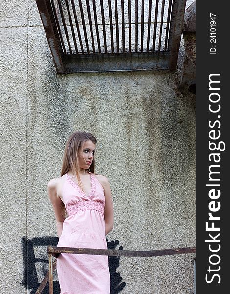 Young Girl Standing On Old Stairs