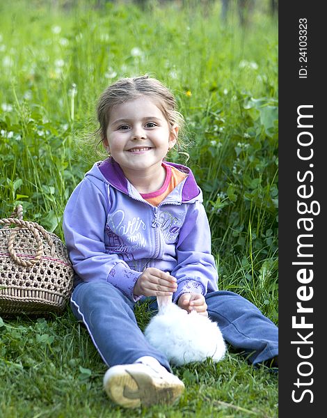 Little Girl And Rabbit On The Grass