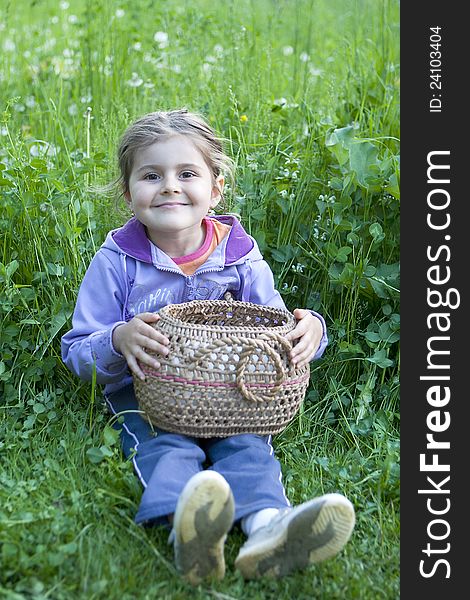 Little Girl With Basket On Grass