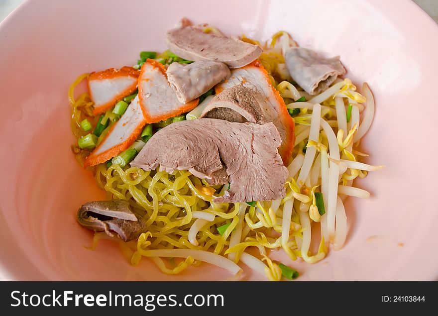 Asian style noodle with pork and vegetable in bowl
