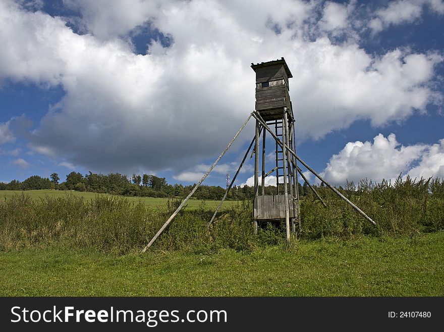 Wooden shelter for hunters on the green between