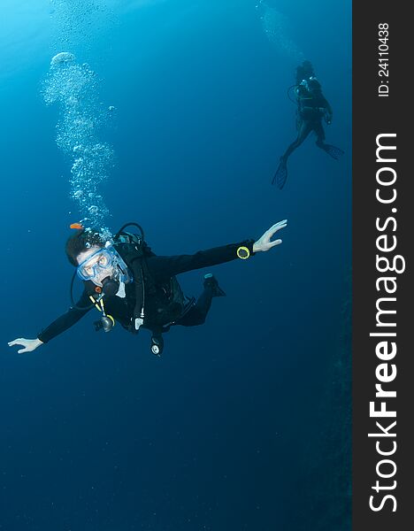 Scuba diver swimming in clear blue water