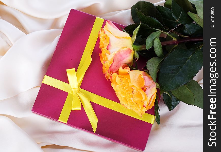 Gift with yellow roses on silk. Gift with yellow roses on silk