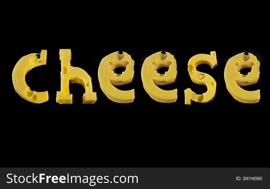 Word Cheese from pieces of cheese isolated on black