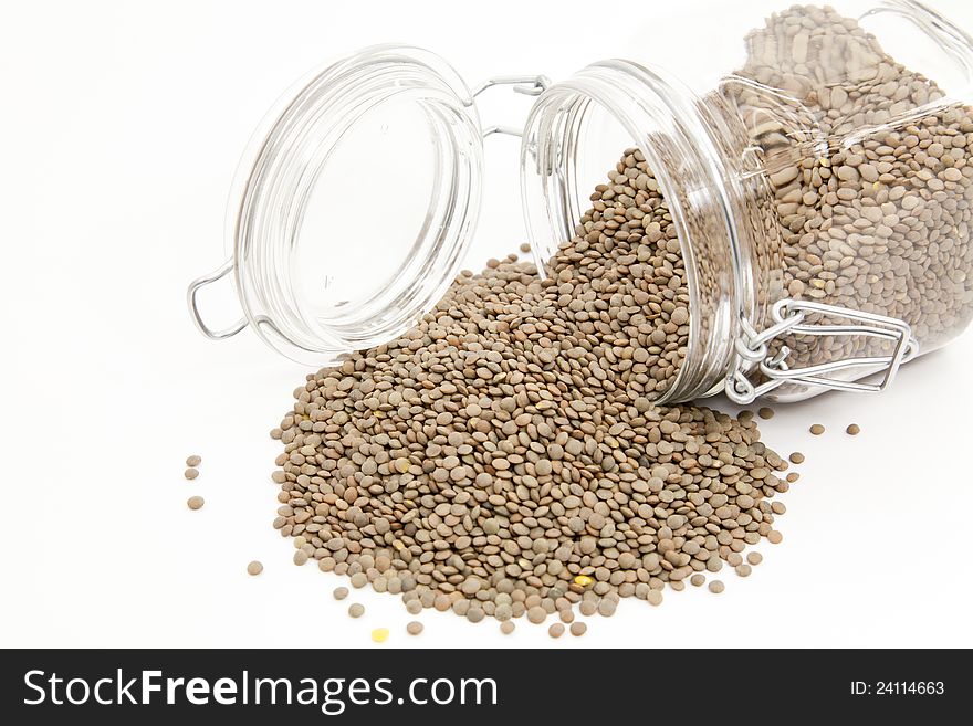Uncooked lentils pot with white background. Uncooked lentils pot with white background