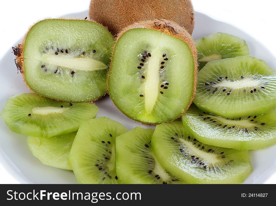 Few brown fresh kiwi fruit, slices isolated