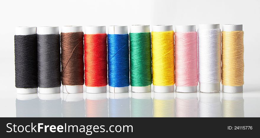 Colorful bobbins on a white background