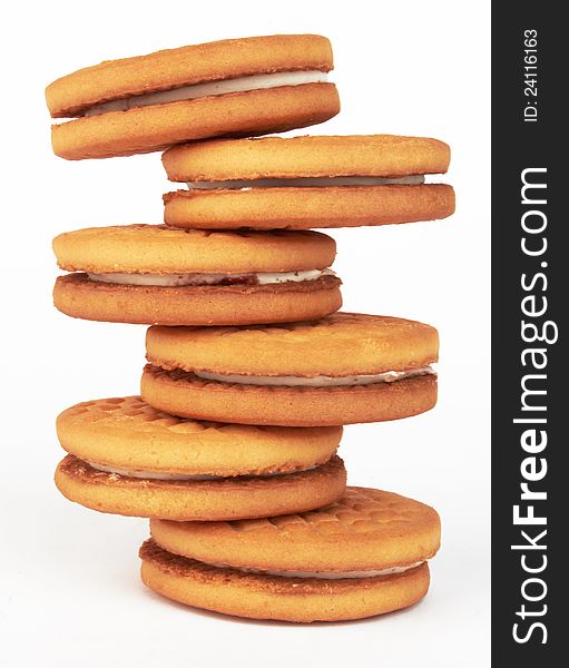 Closeup of a stack of filled cookies on white background