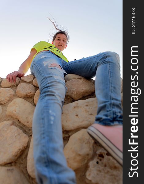 Girl Sitting On Rocks