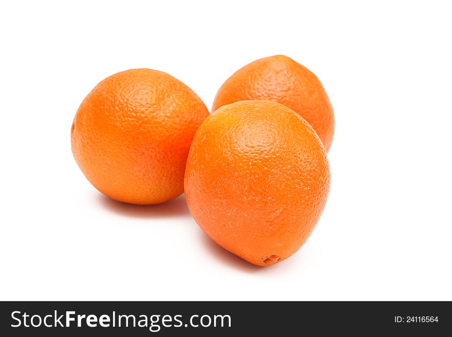Three fresh oranges on an isolated background