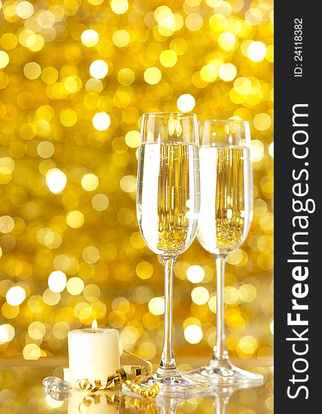 Two glasses of champagne with lights in the background. very shallow depth of field, focus on near glass.